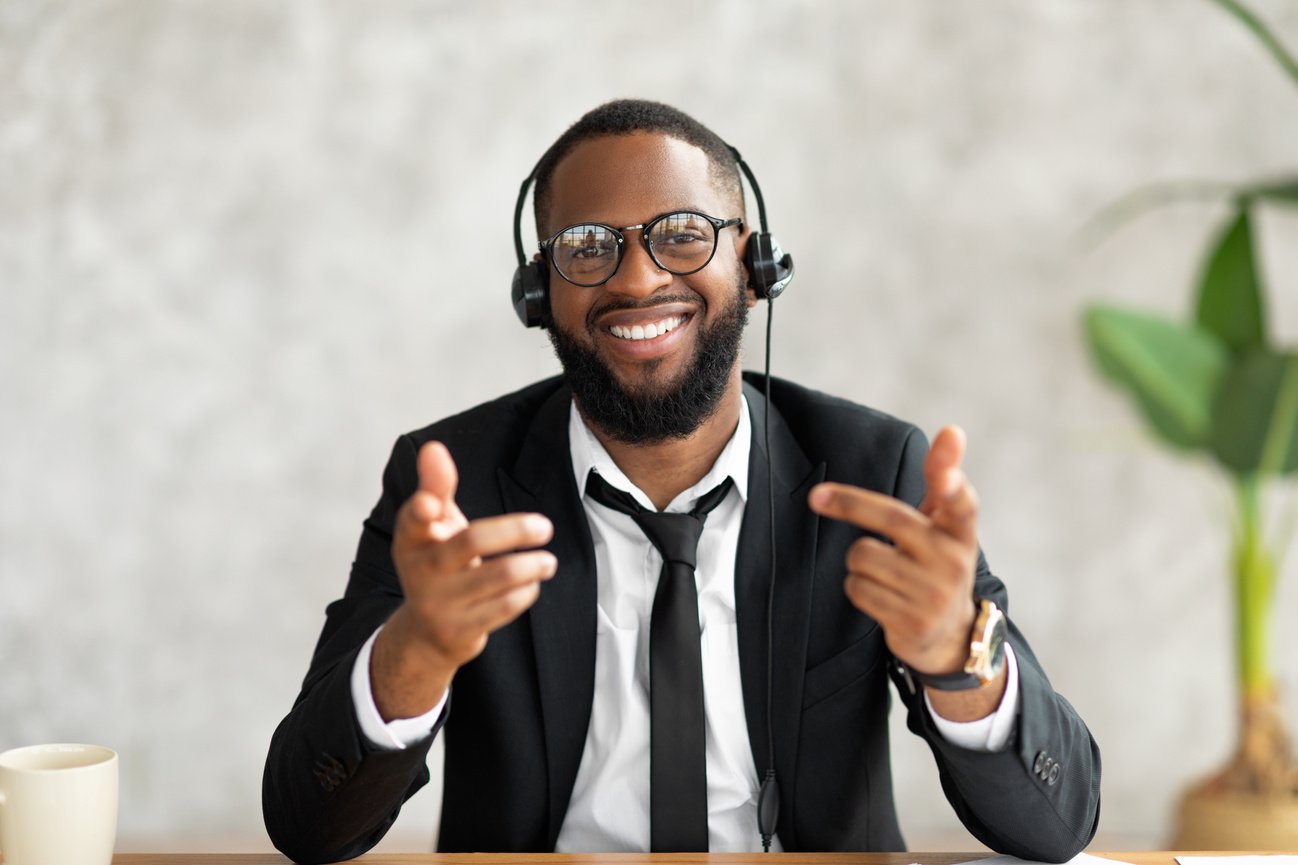 African American Man in Headset Talking to Camera